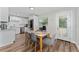 Dining area with hardwood floors and kitchen access at 308 Forest St, Fruitland Park, FL 34731