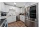 An updated kitchen featuring stainless steel appliances, white cabinets and subway tile backsplash at 308 Forest St, Fruitland Park, FL 34731