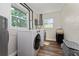 Bright laundry room with white walls, a side-by-side washer and dryer, and two windows at 308 Forest St, Fruitland Park, FL 34731