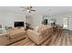 View of living room with hardwood floors, a ceiling fan and an adjacent dining area at 308 Forest St, Fruitland Park, FL 34731
