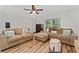 Cozy living room with light walls, hardwood floors, a ceiling fan, and multiple windows at 308 Forest St, Fruitland Park, FL 34731