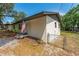 The side of the house has fresh paint, a well-kept yard, and a chain-link fence at 308 Forest St, Fruitland Park, FL 34731