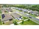 Neighborhood aerial view featuring fenced in backyards and view of a community pond at 3443 Florigold Grove St, Clermont, FL 34711