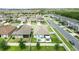 Aerial view of a home with a fenced backyard, patio, and view of a scenic community pond at 3443 Florigold Grove St, Clermont, FL 34711