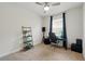Bedroom with neutral carpet, ceiling fan, large window with curtains, and a small workstation at 3443 Florigold Grove St, Clermont, FL 34711