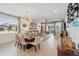 The dining area features lots of light, a statement lighting fixture, and views of the backyard at 3443 Florigold Grove St, Clermont, FL 34711