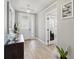 Bright entryway with hardwood floors, modern light fixtures, and a stylish accent table at 3443 Florigold Grove St, Clermont, FL 34711