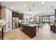 Spacious kitchen features stainless appliances, granite counters, and a view of the open-concept living area at 3443 Florigold Grove St, Clermont, FL 34711