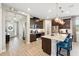 Open kitchen features granite counters, stainless appliances, and a breakfast bar with pendant lighting at 3443 Florigold Grove St, Clermont, FL 34711