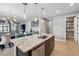 Beautiful kitchen island with granite countertops, stainless steel appliances, and stylish pendant lighting fixtures at 3443 Florigold Grove St, Clermont, FL 34711
