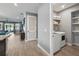 Laundry room with modern washer and dryer, and built-in shelving with ample storage space at 3443 Florigold Grove St, Clermont, FL 34711
