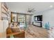 Cozy living room with comfortable seating, view of the backyard, and modern decor with lots of natural light at 3443 Florigold Grove St, Clermont, FL 34711