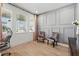 The office space features two velvet chairs, light wood floors, paneled wall, and natural light at 3443 Florigold Grove St, Clermont, FL 34711