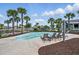 Community splash pool with seating and palm trees in a secure fenced area at 3443 Florigold Grove St, Clermont, FL 34711