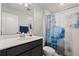 Modern bathroom features a sleek vanity with solid surface countertop and a colorful shower curtain at 352 Smugglers Way, Apopka, FL 32712