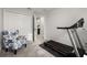 This bedroom has a chair and treadmill on plush grey carpet at 352 Smugglers Way, Apopka, FL 32712