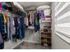 This walk-in closet has carpet and ample storage with racks and shelves at 352 Smugglers Way, Apopka, FL 32712