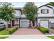 Charming townhomes featuring brick driveways, attached garages and colorful landscaping at 352 Smugglers Way, Apopka, FL 32712
