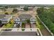 View of townhomes with red shutter accents, brick-paved driveways, and attached one-car garages in a well-maintained community at 352 Smugglers Way, Apopka, FL 32712