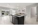 Kitchen island with stainless steel dishwasher and sink, with views of the living room at 352 Smugglers Way, Apopka, FL 32712