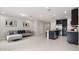 Open-concept living room flows into kitchen featuring stainless steel appliances and island at 352 Smugglers Way, Apopka, FL 32712