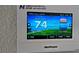 Smart thermostat displaying current room temperature and cooling settings for optimal comfort at 352 Smugglers Way, Apopka, FL 32712