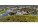 Community pool surrounded by lakes, residential buildings, and green space at 3575 Landing Net Dr, Kissimmee, FL 34746