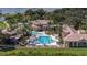 Overhead shot of a community pool with several areas for recreation, landscaping, and nearby lakes at 3575 Landing Net Dr, Kissimmee, FL 34746