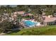 Aerial view of a resort-style pool with lush greenery, lounge seating, and community buildings at 3575 Landing Net Dr, Kissimmee, FL 34746