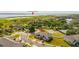 Aerial view of a beautiful home in a community featuring green spaces and a lake at 3575 Landing Net Dr, Kissimmee, FL 34746