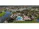 Aerial view of community pool, lakes, residential buildings, and landscaping at 3575 Landing Net Dr, Kissimmee, FL 34746