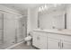 Bathroom featuring a glass shower door, double vanity and neutral tile at 3575 Landing Net Dr, Kissimmee, FL 34746