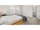 Bedroom with neutral carpeting, bed frame and a glimpse into an ensuite at 3575 Landing Net Dr, Kissimmee, FL 34746