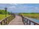 Beautiful curved boardwalk featuring lampposts and scenic water views; community amenity at 3575 Landing Net Dr, Kissimmee, FL 34746
