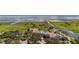 Community pool surrounded by lush landscaping and palm trees overlooking beautiful lake at 3575 Landing Net Dr, Kissimmee, FL 34746