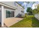 View of the back patio featuring an exterior door and fenced yard at 3575 Landing Net Dr, Kissimmee, FL 34746