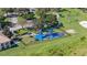 Aerial view of the community playground featuring covered picnic tables, slides, and a fenced perimeter at 3575 Landing Net Dr, Kissimmee, FL 34746