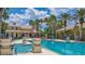 Spacious pool area with decorative planters, lounge seating, and mature palm trees at 3575 Landing Net Dr, Kissimmee, FL 34746