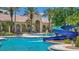 Resort-style pool area with slide and lounge seating, surrounded by lush tropical landscaping at 3575 Landing Net Dr, Kissimmee, FL 34746
