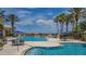 Expansive pool area with ample seating, umbrellas, and a scenic view, perfect for relaxation and entertainment at 3575 Landing Net Dr, Kissimmee, FL 34746