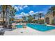 Large pool area with elegant planters, palm trees, and ample seating under a sunny sky at 3575 Landing Net Dr, Kissimmee, FL 34746