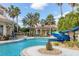 Resort-style pool with a water slide, sun loungers, and lush landscaping, perfect for relaxation and fun at 3575 Landing Net Dr, Kissimmee, FL 34746