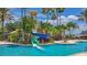Gathering-friendly pool area with a waterslide, lush landscaping, and clear blue water for endless summer fun at 3575 Landing Net Dr, Kissimmee, FL 34746