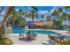 Inviting pool area with tables and umbrellas, surrounded by lush tropical landscaping and a pool slide at 3575 Landing Net Dr, Kissimmee, FL 34746
