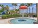 Interactive splash pad with a mushroom-shaped water feature, surrounded by lush landscaping and resort-style amenities at 3575 Landing Net Dr, Kissimmee, FL 34746