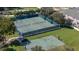 Aerial view of well-maintained tennis and basketball courts available within the residential community at 3575 Landing Net Dr, Kissimmee, FL 34746