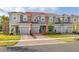 Exterior of gray, multi-Gathering townhouse featuring brick paved driveway and sidewalks at 3575 Landing Net Dr, Kissimmee, FL 34746