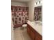 The bathroom features a light countertop, a sink, and a charming fashion-themed shower curtain at 369 St Georges Cir, Eagle Lake, FL 33839