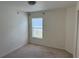 Bright bedroom with neutral carpet and a window at 369 St Georges Cir, Eagle Lake, FL 33839