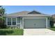 Charming single-story home featuring a two-car garage and well-maintained landscaping at 369 St Georges Cir, Eagle Lake, FL 33839
